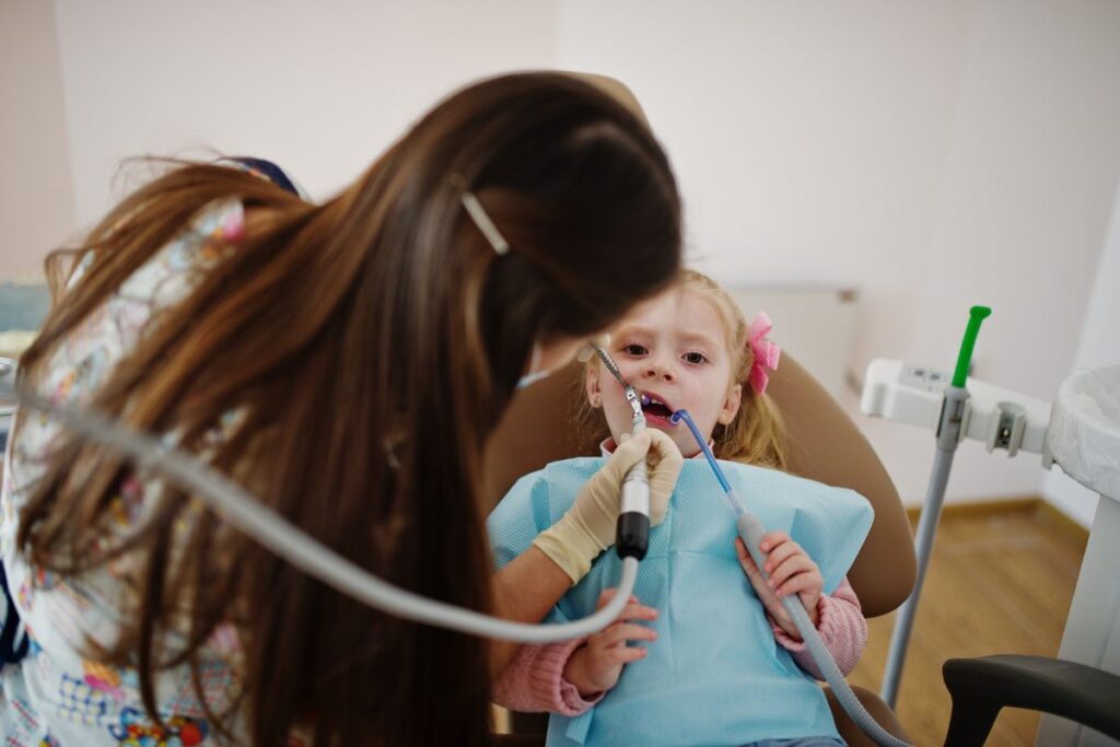 Young child in dental chair receiving examination from dentist in Twin Falls.